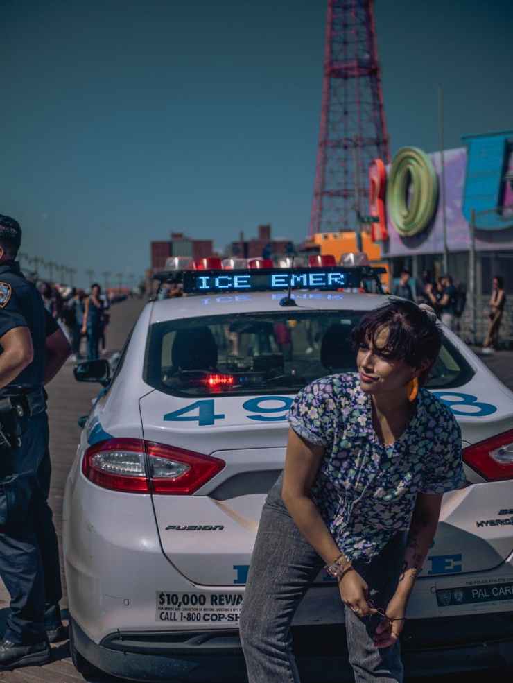 woman in front of police car